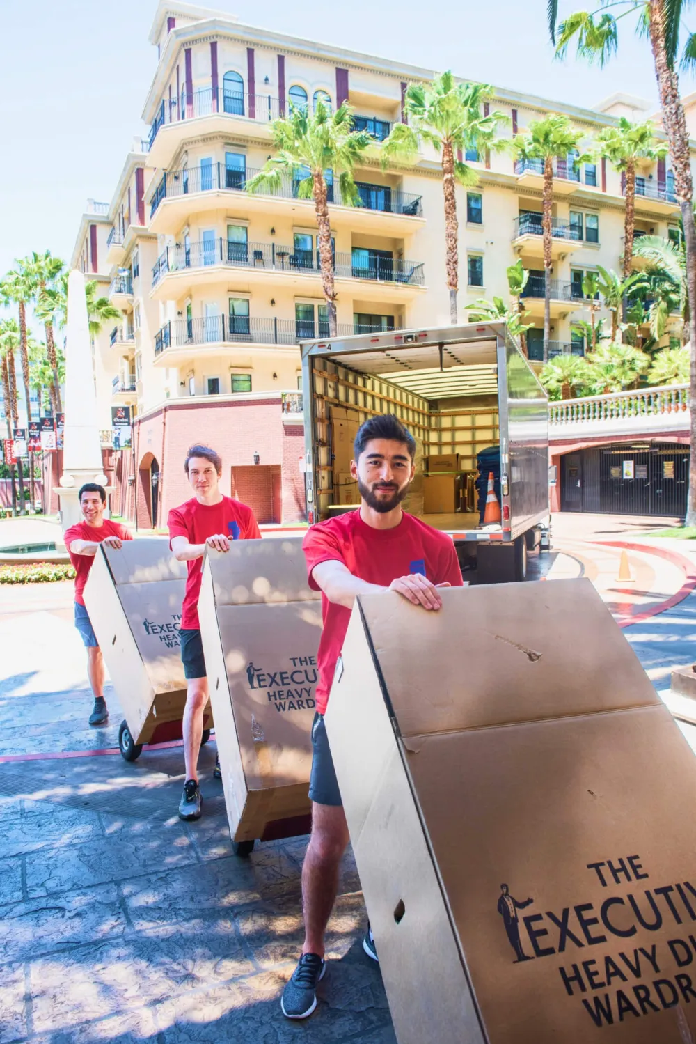 A Reliable Moving Services crew member taping a branded moving box.