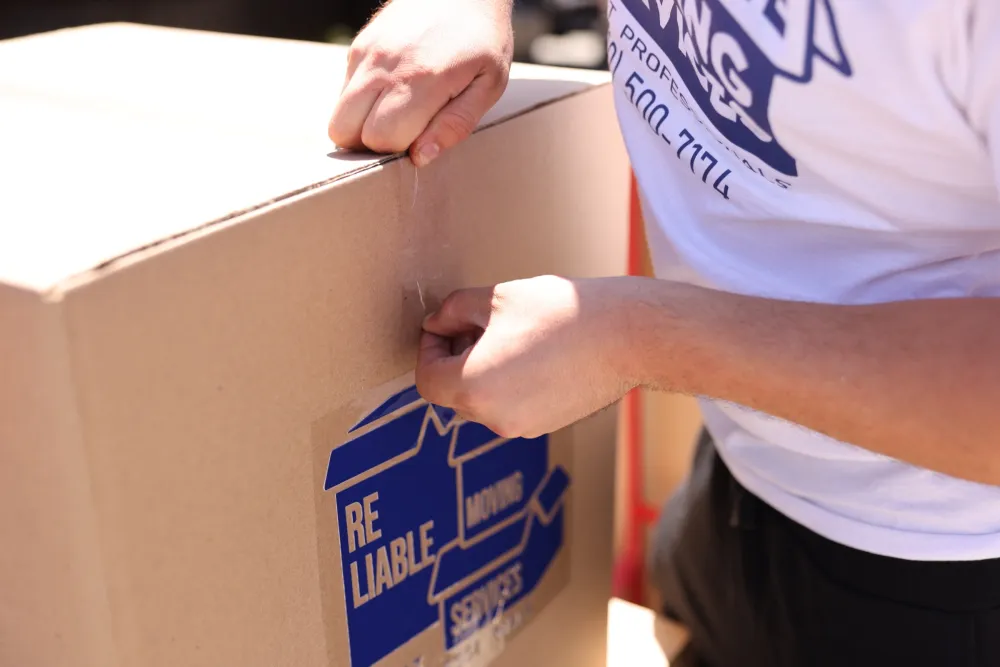 Reliable Moving Services crew packing and labeling boxes on a Los Angeles move.